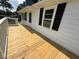 View of newly constructed deck and freshly painted exterior at 902 Roanoke Ave, Henderson, NC 27536
