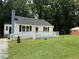 Well-manicured lawn accentuates this lovely home with a welcoming deck at 902 Roanoke Ave, Henderson, NC 27536