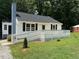 Cozy home displaying a freshly stained deck and chimney at 902 Roanoke Ave, Henderson, NC 27536