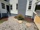 Rear entrance with newly stained deck, fresh paint, stone and rock landscaping at 902 Roanoke Ave, Henderson, NC 27536