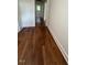 Hallway showcasing hardwood floors, white trim, and neutral paint at 902 Roanoke Ave, Henderson, NC 27536