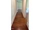 A long hallway with hardwood floors and white walls at 902 Roanoke Ave, Henderson, NC 27536