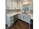 White cabinets, stainless appliances, and marbled quartz countertops in remodeled kitchen at 902 Roanoke Ave, Henderson, NC 27536