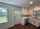 Updated kitchen with white cabinets, stainless steel appliances, and hardwood floors at 902 Roanoke Ave, Henderson, NC 27536