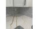 Close up of marbled quartz countertops and patterned backsplash in remodeled kitchen at 902 Roanoke Ave, Henderson, NC 27536