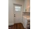 Kitchen features door to backyard, white cabinets, and marbled quartz countertops at 902 Roanoke Ave, Henderson, NC 27536