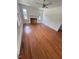 Spacious living room featuring hardwood floors, fireplace, and ceiling fan at 902 Roanoke Ave, Henderson, NC 27536