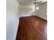 Spacious living room featuring hardwood floors, ceiling fan, and a front door at 902 Roanoke Ave, Henderson, NC 27536