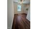 Living space showcasing hardwood floors, fresh paint, and lots of natural light at 902 Roanoke Ave, Henderson, NC 27536