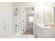 Bright bathroom with a tub, vanity, and a view into a bedroom at 929 Morreene Rd # C31, Durham, NC 27705