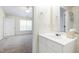 Bright bathroom featuring a white vanity and a glimpse into a bedroom at 929 Morreene Rd # C31, Durham, NC 27705