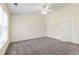 Bright bedroom boasts neutral tones, plush carpeting, a ceiling fan, and plenty of natural light at 929 Morreene Rd # C31, Durham, NC 27705
