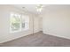 Bright bedroom features neutral walls, plush carpet, and a large window with natural light at 929 Morreene Rd # C31, Durham, NC 27705
