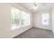 Bright bedroom with a ceiling fan and large windows that bring in natural light for a warm space at 929 Morreene Rd # C31, Durham, NC 27705
