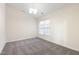 Bright bedroom features neutral tones, plush carpeting, and a window bringing in natural light at 929 Morreene Rd # C31, Durham, NC 27705