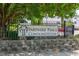 Partners Place Condominiums sign set in a black iron fence and stone base at 929 Morreene Rd # C31, Durham, NC 27705