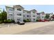 Three story apartment building with beige siding and parking lot with several cars at 929 Morreene Rd # C31, Durham, NC 27705