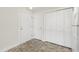 Hallway with gray tiled floor and multiple doors and closets at 929 Morreene Rd # C31, Durham, NC 27705