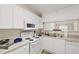 Kitchen with white cabinets and view of the dining room at 929 Morreene Rd # C31, Durham, NC 27705