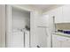 A functional laundry area with washer, dryer, and additional storage cabinets for convenience at 929 Morreene Rd # C31, Durham, NC 27705
