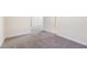 Living room with access to additional rooms and neutral carpeting at 929 Morreene Rd # C31, Durham, NC 27705