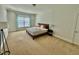 Spacious bedroom featuring a large window and plush carpeting at 9409 Collingdale Way, Raleigh, NC 27617