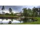 Picturesque golf clubhouse reflected on a pond surrounded by lush landscaping and mature trees at 9409 Collingdale Way, Raleigh, NC 27617