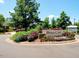 Swim and tennis pavilion entrance sign with lush landscaping featuring colorful flowers and mature trees at 9409 Collingdale Way, Raleigh, NC 27617