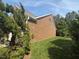 Lush green lawn surrounds the brick home, showcasing classic architecture and landscaping at 9409 Collingdale Way, Raleigh, NC 27617