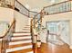Staircase leading to the upper level and a view of the entry hallway showcasing hardwood floors at 9409 Collingdale Way, Raleigh, NC 27617