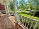 Spacious covered front porch featuring brick flooring, white railings, and serene neighborhood views at 9409 Collingdale Way, Raleigh, NC 27617