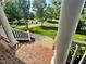 Scenic view of the neighborhood from the covered front porch with brick flooring at 9409 Collingdale Way, Raleigh, NC 27617