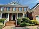 Inviting brick front porch with white columns and a beautifully landscaped yard at 9409 Collingdale Way, Raleigh, NC 27617