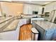 Open kitchen with stainless appliances, granite countertops, and hardwood floors at 9409 Collingdale Way, Raleigh, NC 27617