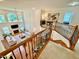 Open-concept living room with a fireplace, large windows, and view from the second story loft at 9409 Collingdale Way, Raleigh, NC 27617