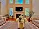Bright living room with tall windows, fireplace, stylish decor, and comfortable seating for gatherings at 9409 Collingdale Way, Raleigh, NC 27617
