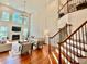 Elegant living room with soaring ceilings, a fireplace, large windows, and a staircase leading to the second floor at 9409 Collingdale Way, Raleigh, NC 27617