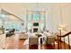 Open concept living room featuring hardwood floors, fireplace, high ceilings, and access to the dining room at 9409 Collingdale Way, Raleigh, NC 27617
