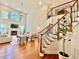 View of the living room with hardwood floors, fireplace, soaring ceilings, staircase, and comfortable seating at 9409 Collingdale Way, Raleigh, NC 27617