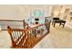 Loft area with foosball table overlooking the living room, and staircase with wood railings at 9409 Collingdale Way, Raleigh, NC 27617