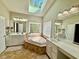 Luxurious bathroom features a soaking tub, double vanities, and a skylight at 9409 Collingdale Way, Raleigh, NC 27617