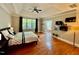 Large main bedroom with wood floors, tray ceiling, and an ensuite bathroom at 9409 Collingdale Way, Raleigh, NC 27617