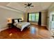 Spacious main bedroom with wood floors, tray ceiling, and large windows at 9409 Collingdale Way, Raleigh, NC 27617