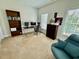 Well-lit home office with a large desk, dual monitors, and comfortable seating at 9409 Collingdale Way, Raleigh, NC 27617