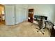 Bright home office with a large desk, dual monitors, and built-in bookshelves at 9409 Collingdale Way, Raleigh, NC 27617