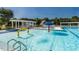 Bright community pool featuring fountains, slides, and ample seating under shaded pergolas at 9409 Collingdale Way, Raleigh, NC 27617