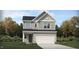 Charming two-story home features a pristine lawn and a two-car garage at 1007 Red Roses Ave, Durham, NC 27703