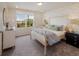 Cozy bedroom featuring stylish decor, large window, and comfortable furnishings, creating a welcoming space at 1009 Red Roses Ave, Durham, NC 27703