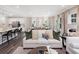 Open-concept living space with modern furnishings and decor, connecting the living room, dining room, and kitchen at 1009 Red Roses Ave, Durham, NC 27703