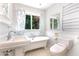 Elegant bathroom with clawfoot tub, pedestal sink and wainscoting at 106 Wolfs Trl, Chapel Hill, NC 27516
